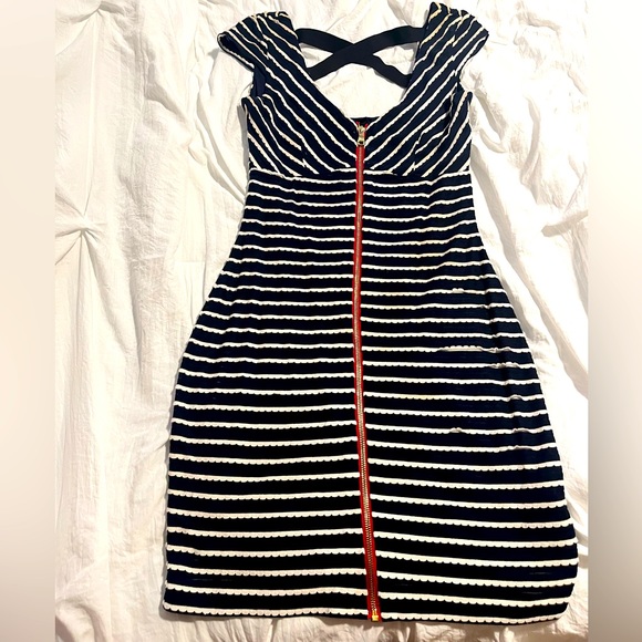 Guess mini dress with cross back detail and zipper in the front. Fair condition. - Picture 1 of 4